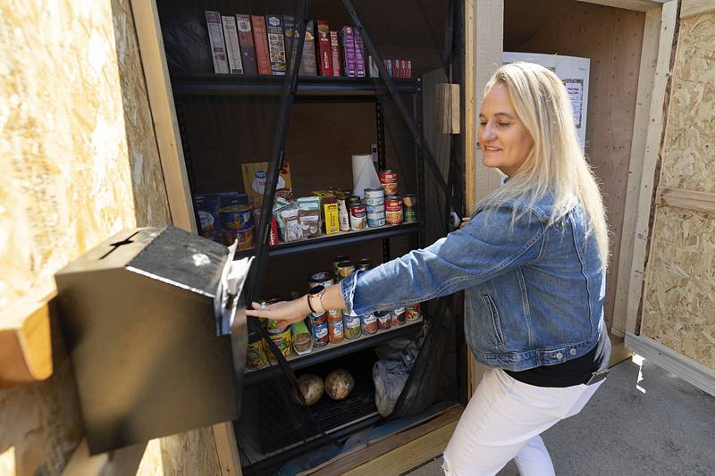 Joyce Lewis shows off the pantry area Thursday, June 20, 2024 of the newly opened Amboy rural mini food center. The center is open 24 hours a day and is located outside of Teen Turf. The center is the third to be built.
