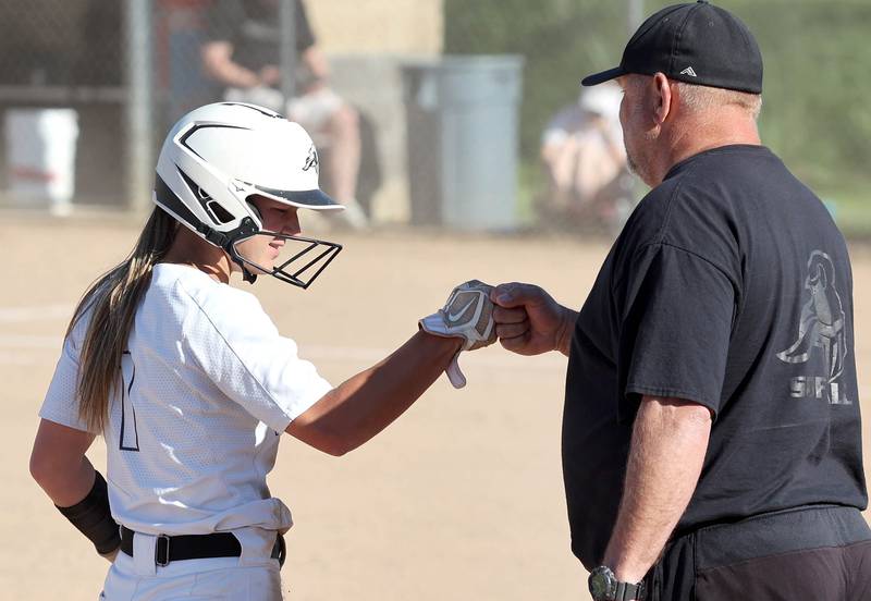 Kaneland's Kailey Plank is congratulated by head coach Mike Kuefler after reaching third Friday, June 3, 2022, during their IHSA Class 3A Sectional final game against Belvedere North at Sycamore High School.