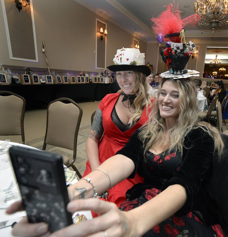 Karli Sarver and Haley Burch take a selfie Friday, Nov. 11, 2022, at the Grand Bear Lodge in Utica during the NCI ARTworks Mad Hatter’s Ball.