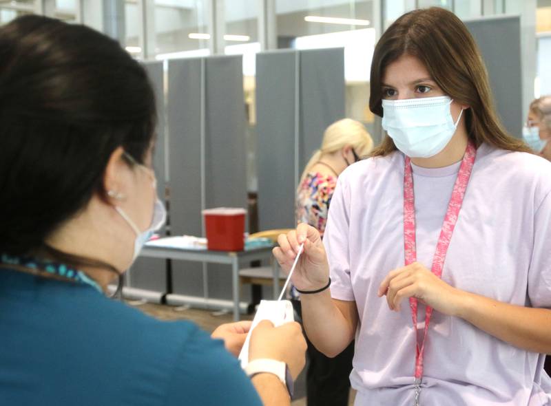 Kayla Boyd, a student-athlete at Kishwaukee College, prepares to take a COVID-19 test Wednesday, Aug. 25, 2021, at the school during a DeKalb County Health Department event where COVID-19 testing and vaccines were made available to students and employees.