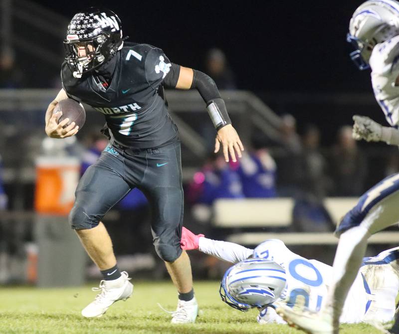 Woodstock North’s Parker Halihan breaks a tackle en route to scoring a touchdown against Woodstock in varsity football at Woodstock North High School on Friday, October 24, 2025.