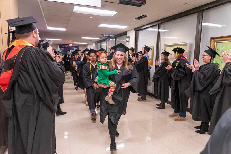 Graduates are applauded by McHenry County College faculty and staff after the winter commencement ceremony Dec. 14, 2024.