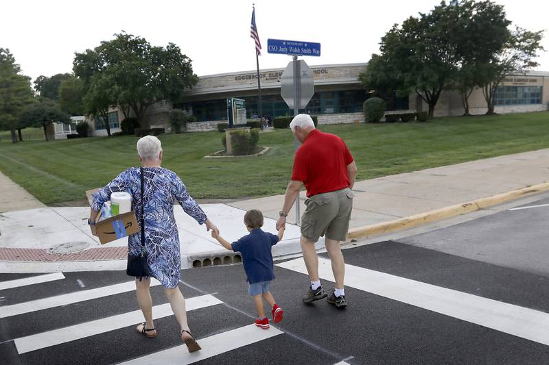 Pam and Steve Zebich walk Jayce, to Edgebrook Elementary School on Tuesday, Aug. 15, 2023, so he can meet his teacher and drop off school supplies.