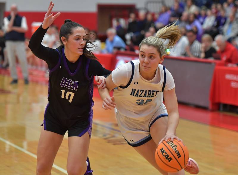 Nazareth’s Stella Sakalas drives as Downers Grove North’s Campbell Thulin (10) defends during the Class 4A Hinsdale Central Sectional final game on February 26, 2026 at Hinsdale Central High School in Hinsdale.