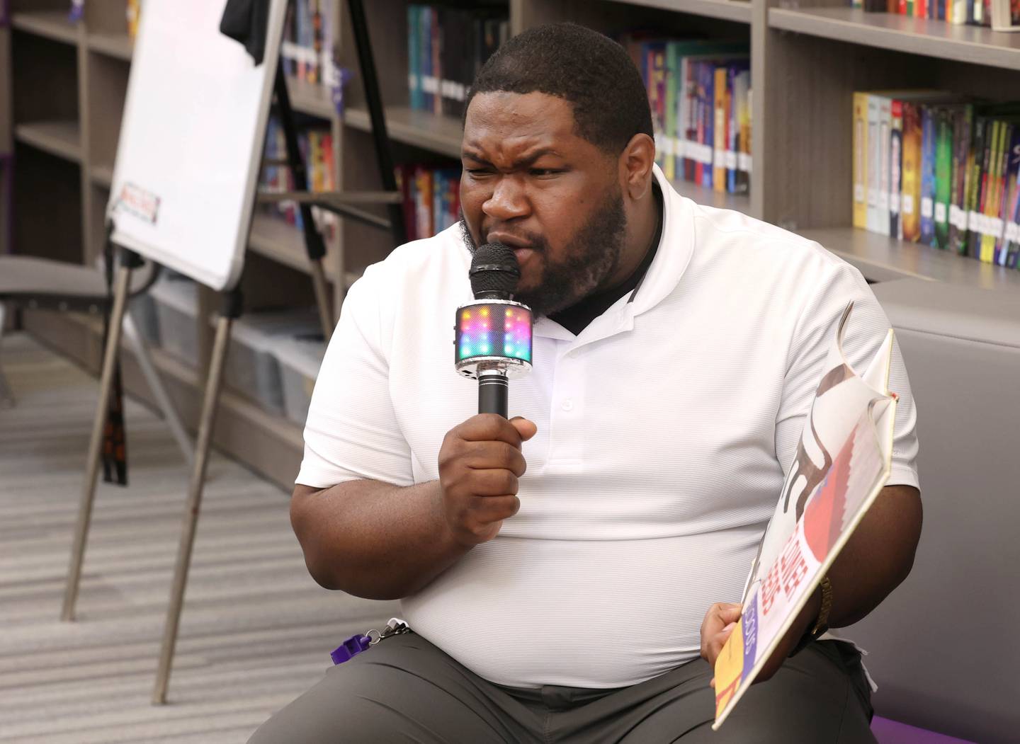 Mitchell Elementary School librarian Alontae McCain reads to first graders Thursday, March 19, 2026, in the library at the school in DeKalb.