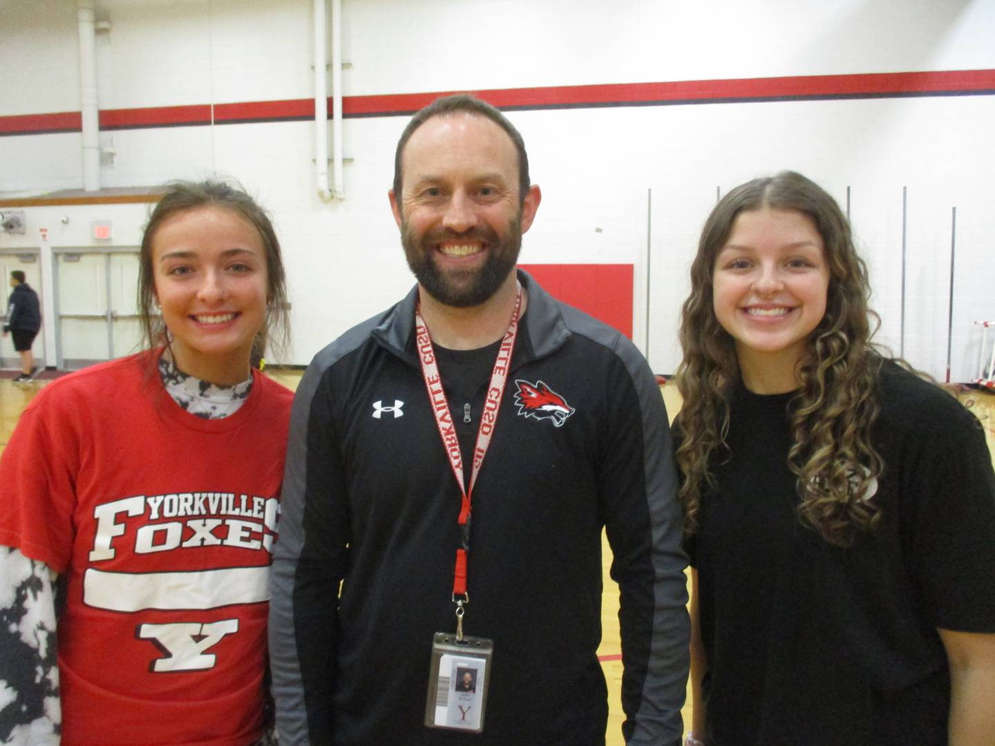 Yorkville High School physical education teacher John Ernser is flanked by two of the "peer leaders" in his adapted PE class. They are junior Kayla Dudek, left, and senior McKenna Calloway.