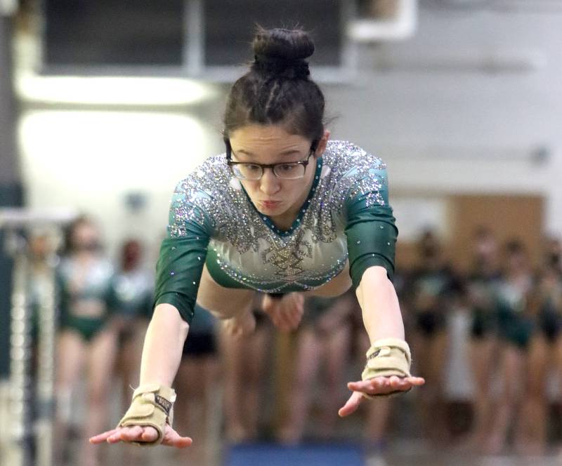 Glenbard West’s Skylar Oh competes in the vault during varsity gymnastics at Biester Gymnasium on the campus of Glenbard West High School in December.