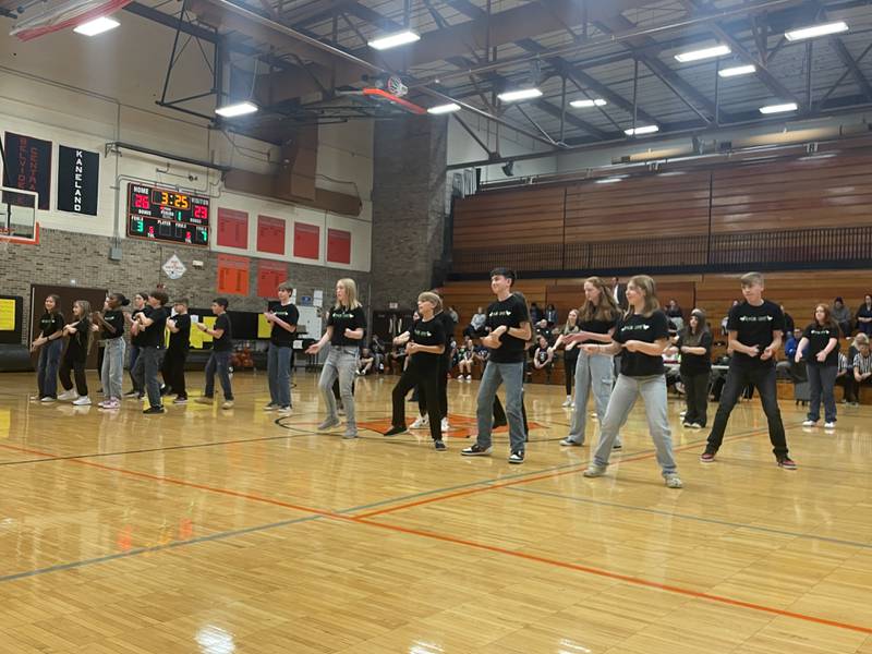 The A Capella group, Fade-Out, performs a musical number for the crowd during halftime Monday, Dec. 2, 2024, at the annual charity basketball game held at Huntley Middle School in DeKalb.