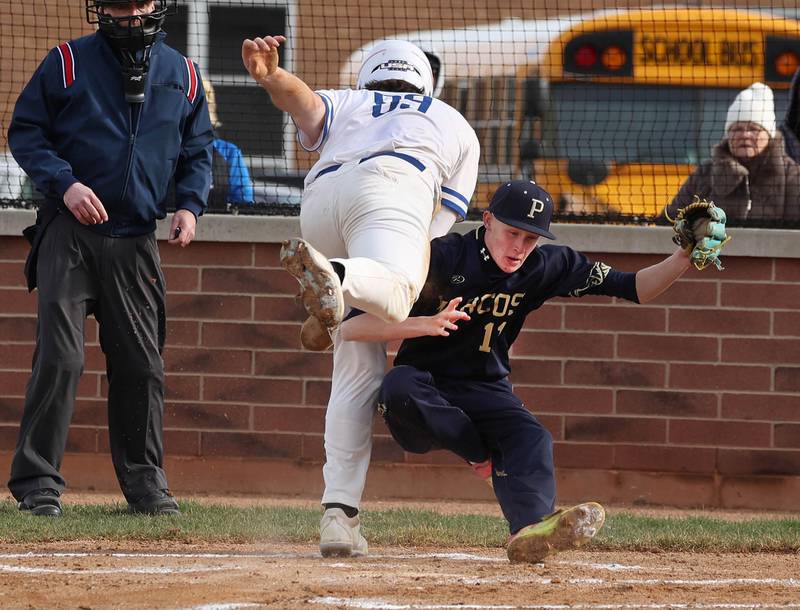 Hinckley-Big Rock’s Martin Ledbetter collides with Polo’s Jackson Willis as he crosses the plate scoring on a wild pitch during their game Thursday, April 3, 2025, at Hinckley-Big Rock High School.