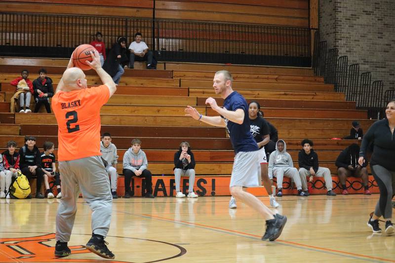 Gregory Blasky (left) takes to the hardwood Monday, Dec. 5, 2022 in the Toys for Tots community basketball game.