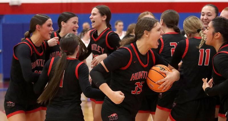 Huntley’s Red Raiders celebrate a win over Maine South in Komaromy Holiday Classic varsity girls basketball championship game action on Monday, Dec. 30, 2024, at Dundee-Crown High School in Carpentersville.