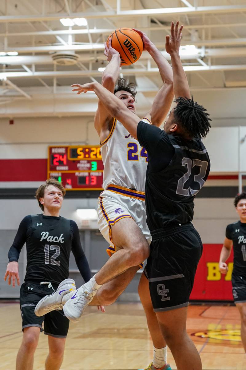 Downers Grove North's Aidan Akkawi (24) shoots the ball in the post over Oswego East's Torrin Ross (23) during a Batavia Night of Hoops Basketball game at Batavia High School on Saturday, Jan. 25, 2025.