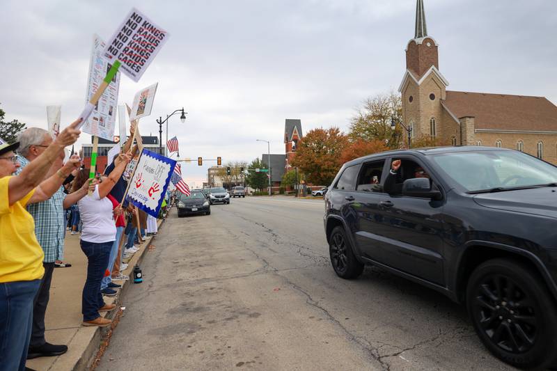 A passerby interacts in approval toward protesters in the No Kings Rally on Saturday, Oct. 18, 2025, at the Kankakee County Courthouse.