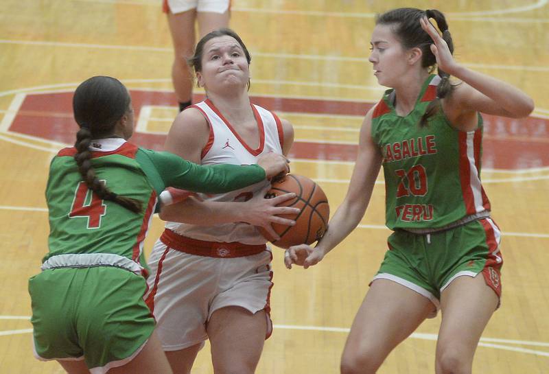Ottawa’s Kendall Lowery is stopped by LaSalle Peru’s Brooklyn Ficek and Bailey Pode n the 2nd period on Wednesday Dec. 7, 2022 at Kingman Gymnasium in Ottawa