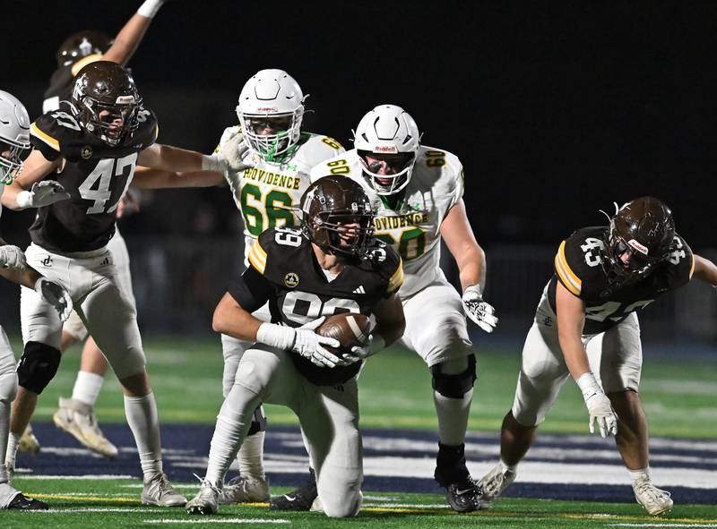 Joliet Catholic's Ian Campbell (99) recovers a fumble during the conference game against Providence Catholic on Friday, OCT. 24, 2025, at Joliet.