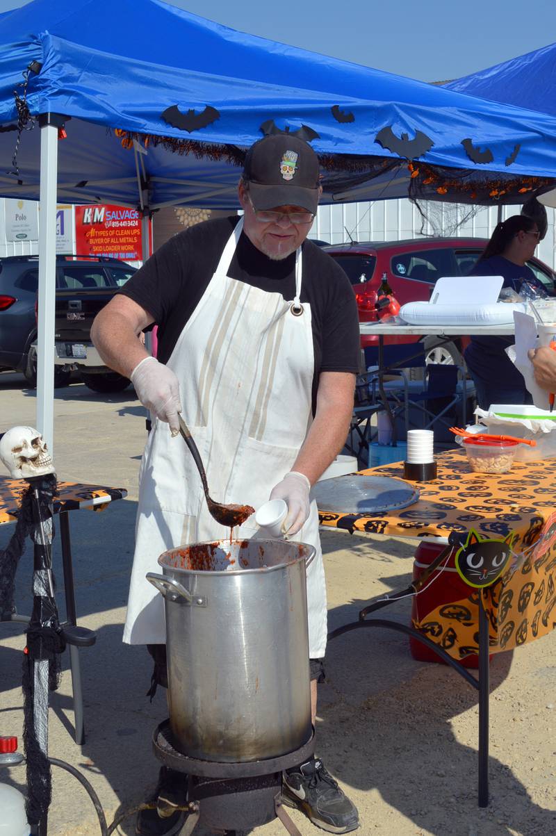 Jason Dean fills a bowl with his vampire chili on Sept. 30, 2023, during Polo's Chili Cook-Off. His chili was one of nine entries. The cook-off was held in the city-owned lot next to the Shell station; it was the first time the event has taken place since 2019.