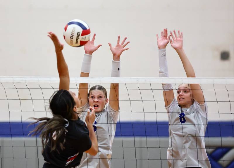Princeton's Caroline Keutzer (left) and Keighley Davis team up for a block in Tuesday's match against Kewanee at Prouty Gym. The Tigresses won 25-8, 25-22.