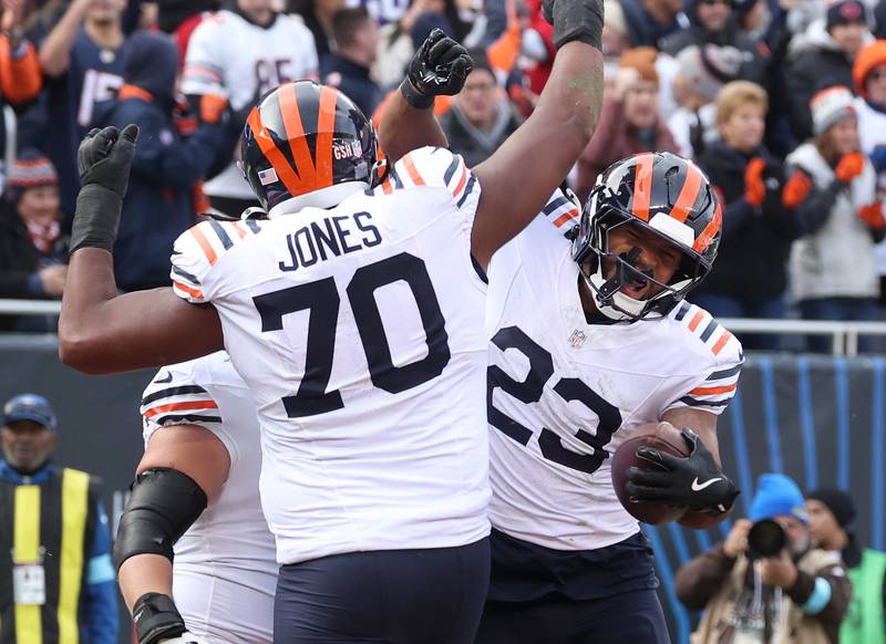 Chicago Bears running back Roschon Johnson (right) celebrates his touchdown with Chicago Bears offensive tackle Braxton Jones during their game against the Minnesota Vikings Sunday, Nov. 24, 2024, at Soldier Field in Chicago.