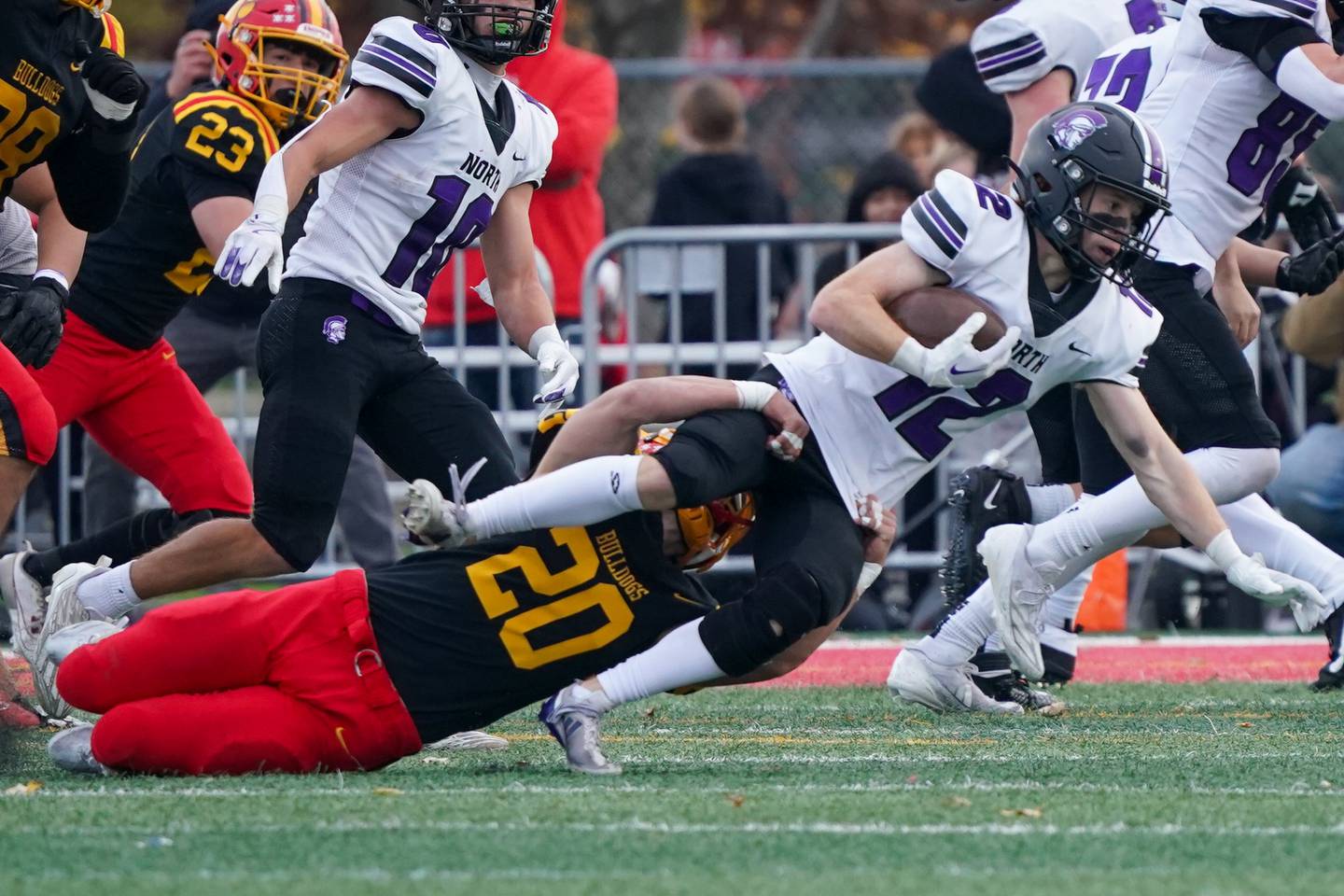 Batavia’s Chase Osborne (20) tackles Downers Grove North's Max Troha (12) during a class 7A quarterfinal playoff football game at Batavia High School on Saturday, Nov. 16, 2024.