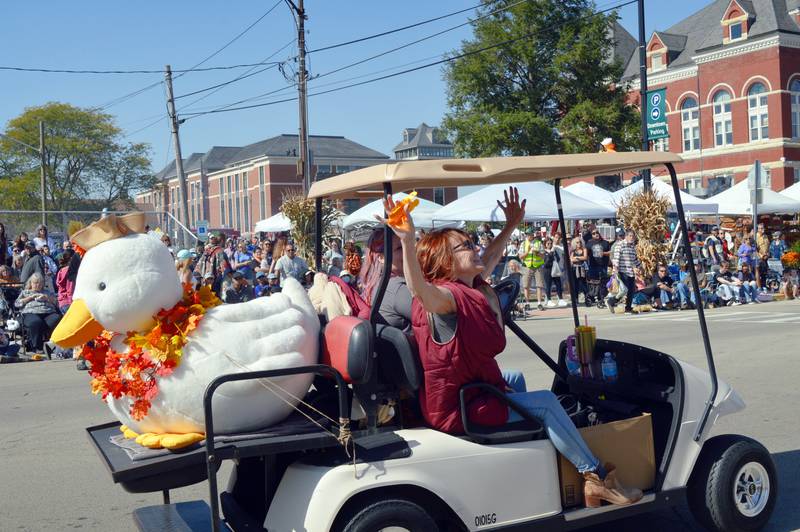 Longtime Autumn on Parade Board President Debbie Dickson waves to a clapping crowd after being recognized for her years of service on Sunday, Oct. 6, 2024, prior to the Harvest Time Parade. Dickson plans to step down from the Board after this year.