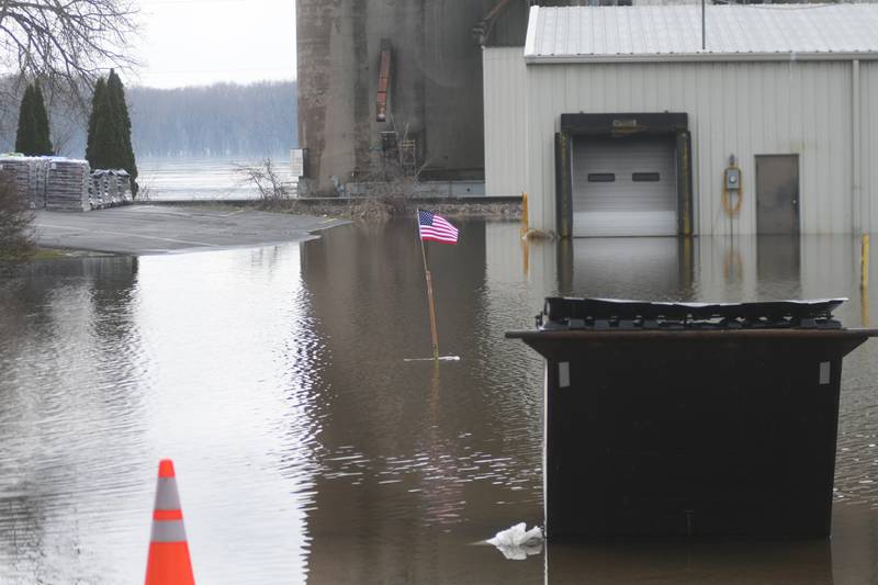 Someone placed an American flag on a pole behind the downtown businesses in Savanna in April 2019 as the Mississippi River's water levels increased forcing business owners to put out sandbags.
