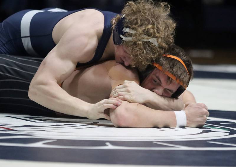 Crystal Lake Central’s Tommy Tommasello, bottom, battles Cary-Grove’s Noah Pechotta at 165 pounds in varsity wrestling Thursday, Dec. 19, 2024 at Cary-Grove High School in Cary.