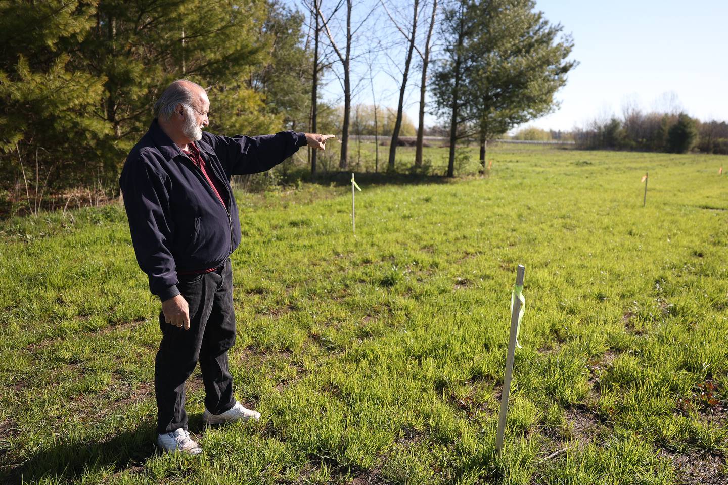 Mistie Hill Vineyard owner Rich Strylowski points to the area that the new wine tasting and processing building will be built on Saturday, April 13 in Custer Park.
