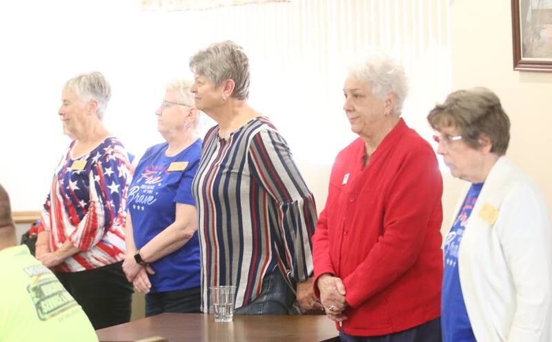 Quilts of Valor volunteers and sewers of the quilts stand to be recognized during the Quilt of Valor ceremony on Saturday, April 19, 2025 at the Moose Lodge in Princeton. It takes 100 hours to make a single quilt.