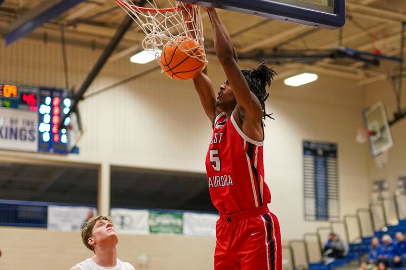 West Aurora's Terrence Smith (5) dunks the ball during a MLK Day of Hoops basketball game against Geneva at Geneva High School on Monday, Jan. 20, 2025.