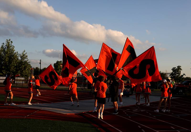 St. Charles East flag bearers get organized before the season opener against Lincoln-Way Central in St. Charles on Friday, Aug. 26, 2022.