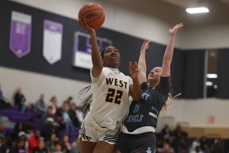 Joliet West’s Makayla Chism lays in a shot against Joliet Catholic in the WJOL Basketball Tournament at Joliet Junior College Event Center on Monday