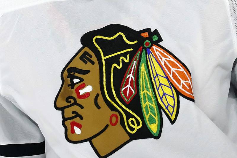 FILE - In this May 3, 2021, file photo, the Chicago Blackhawks logo is displayed on a jersey in Raleigh, N.C. The Blackhawks are holding a briefing Tuesday, Oct. 26, 2021, to discuss the findings of an investigation into allegations that an assistant coach sexually assaulted a player in 2010.  (AP Photo/Karl B DeBlaker, File)