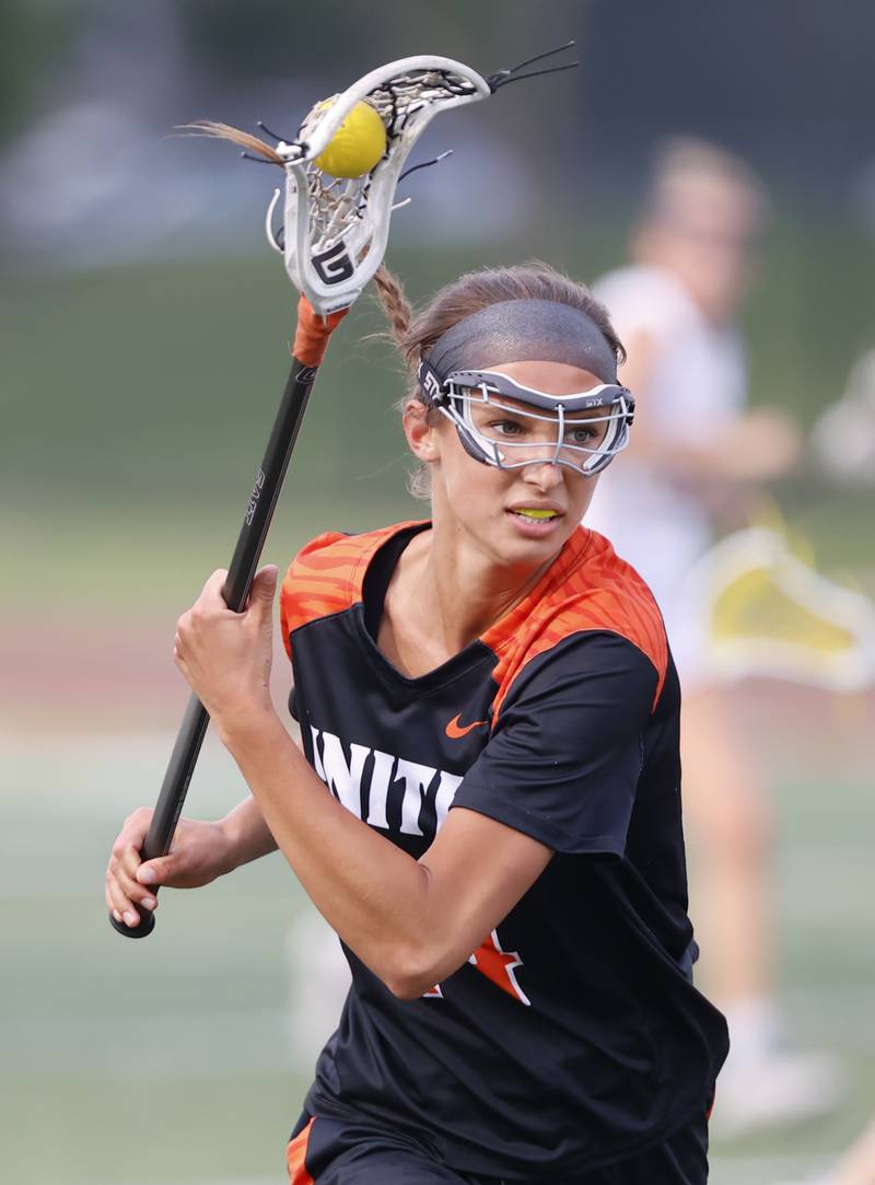 Crystal Lake Central Coop's Addie Bechler (14) runs with the ball during the lacrosse state semi-final match between Crystal Lake Central and Loyola Academy on Thursday, June 5, 2025 in Hinsdale.