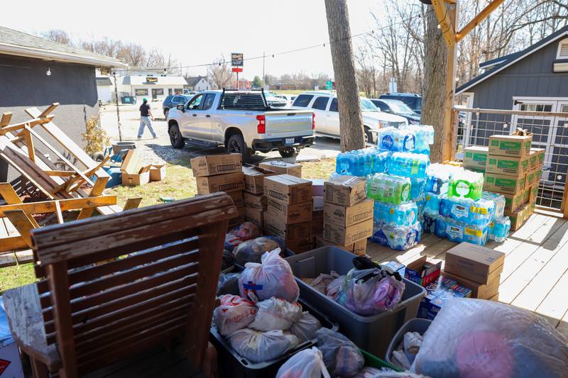 Donations pile up on the outdoor stage at the Fun Hub on March 12, 2026. The small bar transformed into a bustling hub of supplies, food and resources following the March 10 tornado that caused destruction in Aroma Township and across Kankakee County.