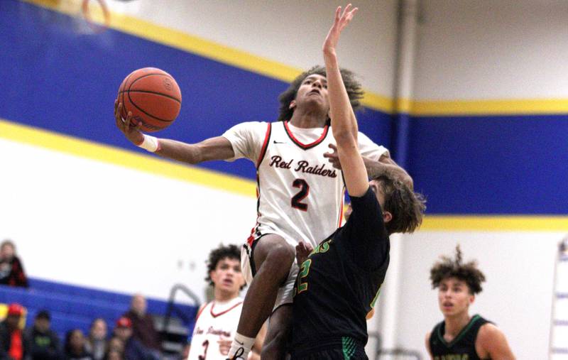 Huntley’s Omare Segarra takes the ball to the hoop against Crystal Lake South in varsity basketball tournament title game action at Johnsburg Friday.