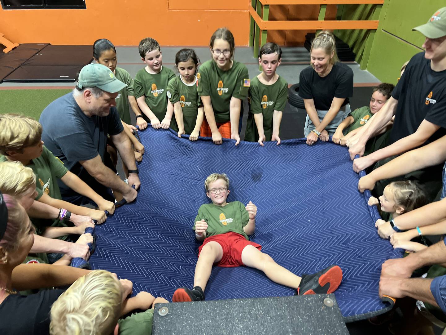 Participants at Hot Ground Gym in Libertyville take part in a trust fall exercise.