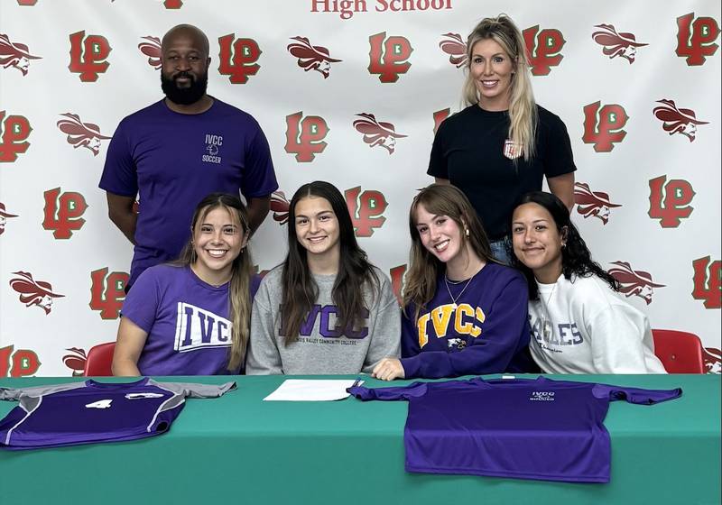 La Salle-Peru seniors (seated from left) Litzy Lopez, Abigail Poole, Danica Scoma and Coral Garcia have signed to play soccer at IVCC. They were joined at their signing by IVCC coach Gerald Stuart (standing, left) and L-P coach Christin Pappas.