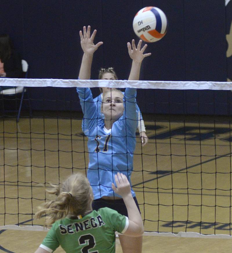Marquette's Avery Durdan rises in an attempt to block the attack of Seneca's Neely Hougas in the opening set Thursday, Sept. 1, 2022, at Bader Gym in Ottawa.