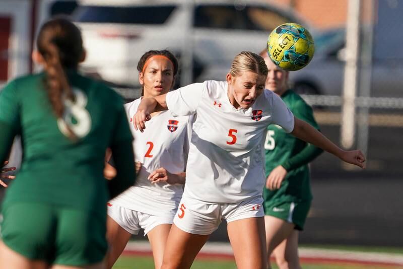 Oswego’s Aubrey Eirich (5) heads the ball against Bartlett during a soccer mach in the Plainfield Classic  at Plainfield North High School on Tuesday, April 15, 2025.