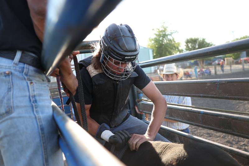 Dominic Dubberstine-Ellerbrock makes last minute adjustments with the bull before his ride. Dominic will be competing in the 2022 National High School Finals Rodeo Bull Riding event on July 17th through the 23rd in Wyoming. Thursday, June 30, 2022 in Grand Ridge.