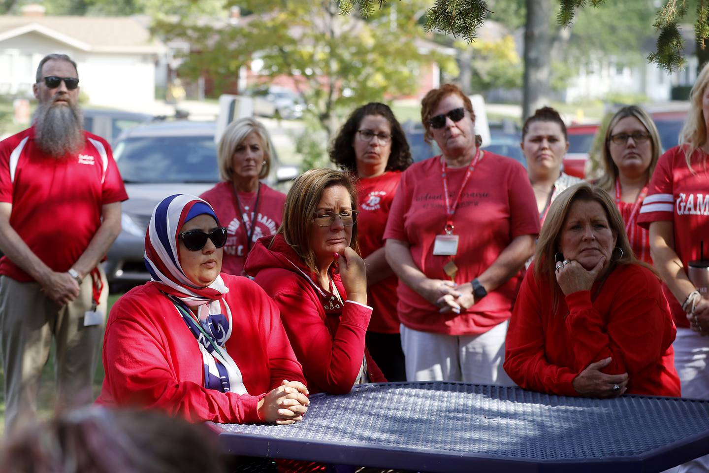 Members of the Crystal Lake paraprofessional union (CLASS) meet outside Lundahl Middle School, on Monday, Aug. 28, 2023, to hear an update about the union's complaint against District 47 for using a staffing agency to fill paraprofessional positions before bargaining with the union.