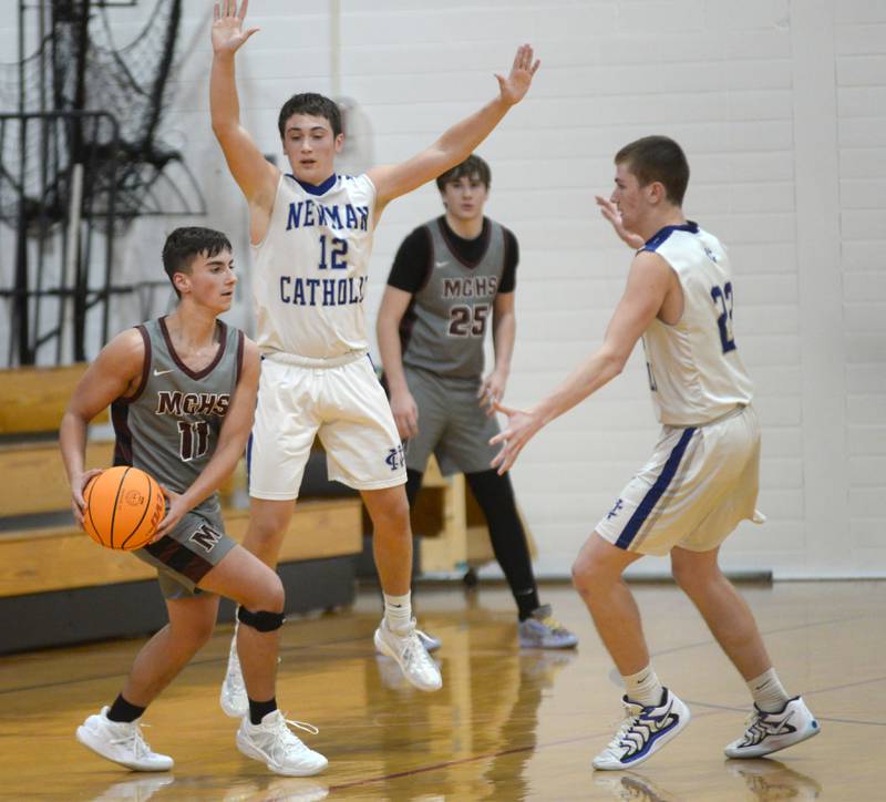 Newman's Evan Bushman (12) and Ashton Miner (22) guard Marengo's Oliver Nichols (11) on Friday, Nov. 29, 2024 at the Oregon Thanksgiving Tournament at the Blackhawk Center in Oregon.