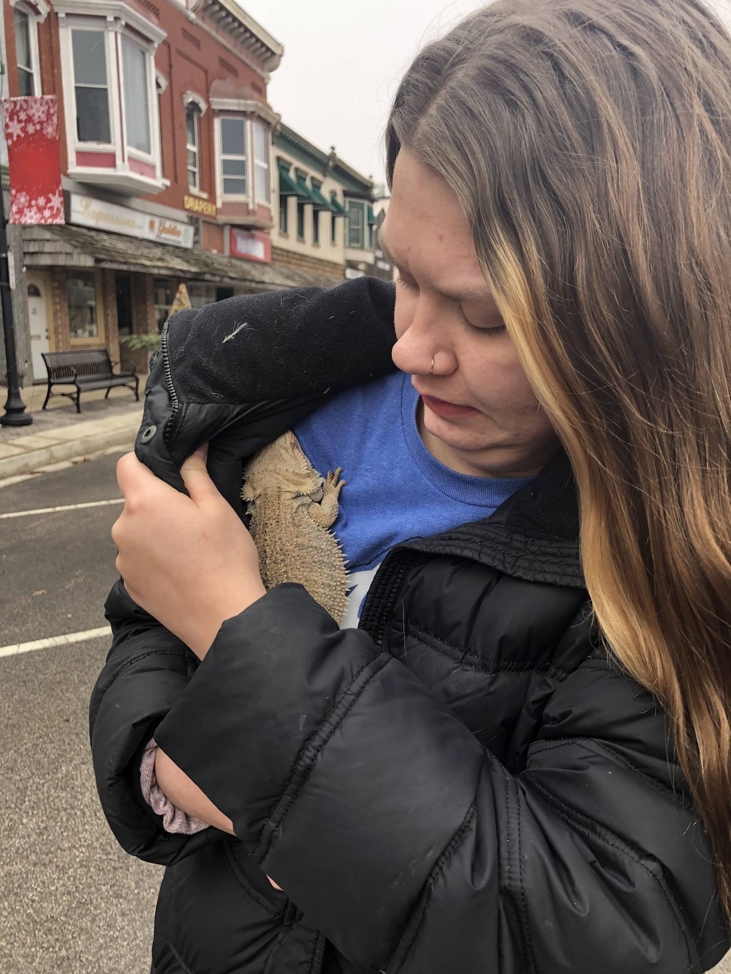 UJ Pets Co-Owner Andora Cearnes keeps a rescued bearded dragon warm after it was found Friday morning in the aftermath of a fire on the 700 block of Illinois Avenue in Downtown Mendota.