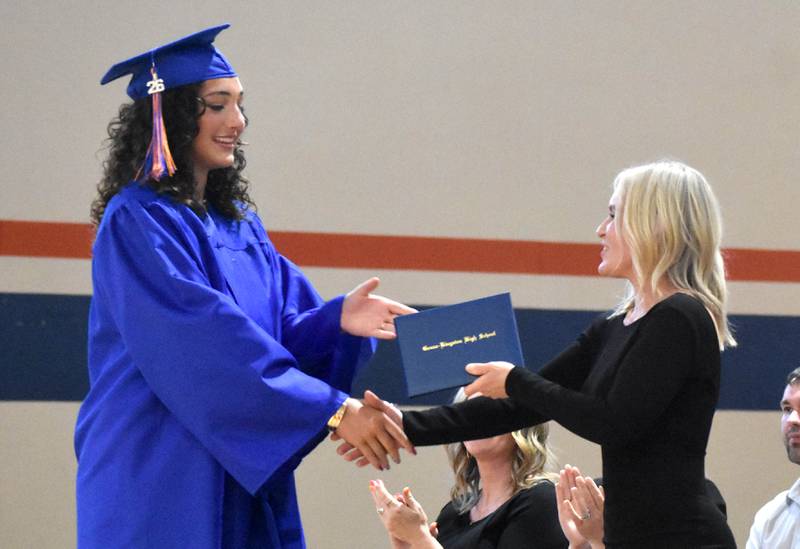 Genoa-Kingston’s Regan Creadon receives her diploma from School Board President Melyssa Gustafson Sunday, May 17, 2026, during the commencment ceremony at Genoa-Kingston High School.