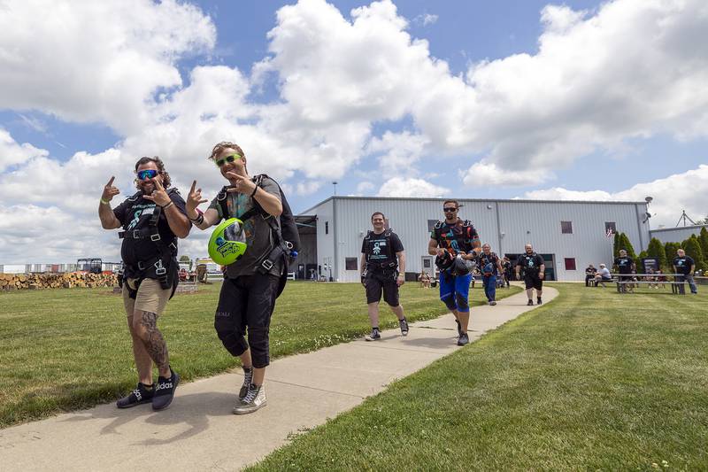 The first group of the day makes their way to the airplane Friday, June 27, 2025, for the Valor Support Project’s skydiving event to raise awareness for PTSD.