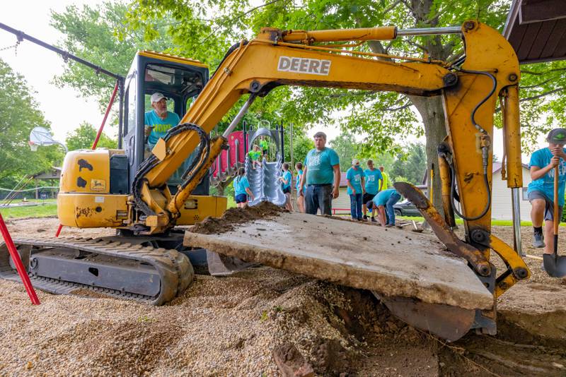 Christian Shanklin uses his excavator to remove an old section of concrete slab from Ray Barto Memorial Park on June 3, 2025 in Seatonville.