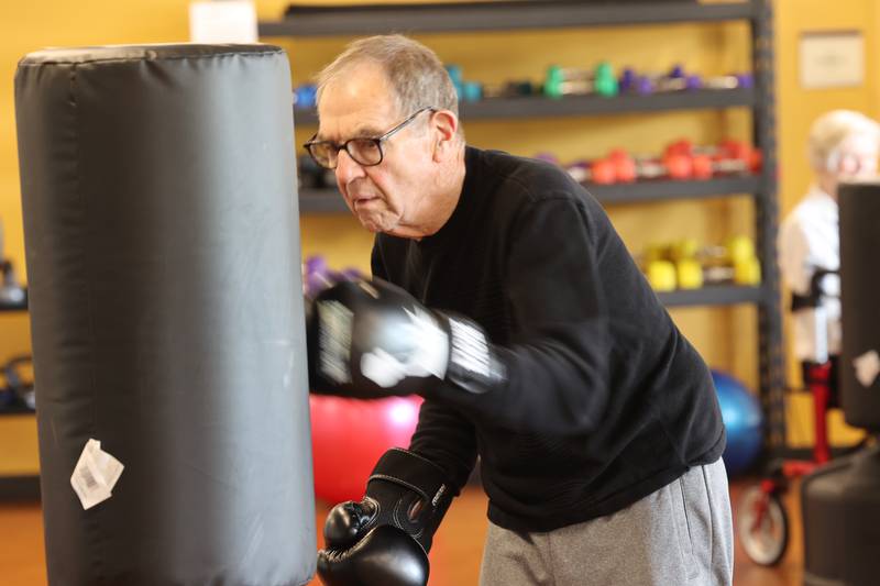 Peter Schram hits the bag Friday, April 28, 2023, during Rock Steady Boxing for Parkinson's Disease class at Northwestern Medicine Kishwaukee Health & Wellness Center in DeKalb. The class helps people with Parkinson’s Disease maintain their strength, agility and balance.