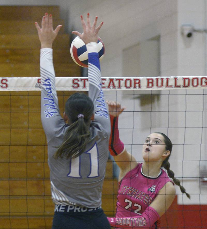Wilmington’s Molly Southall (11) rises to set a block against Streator freshman Avery Gribbin (22) during the opening set of their ICE Conference match Tuesday, Oct. 14, 2025, at Pops Dale Gymnasium in Streator.