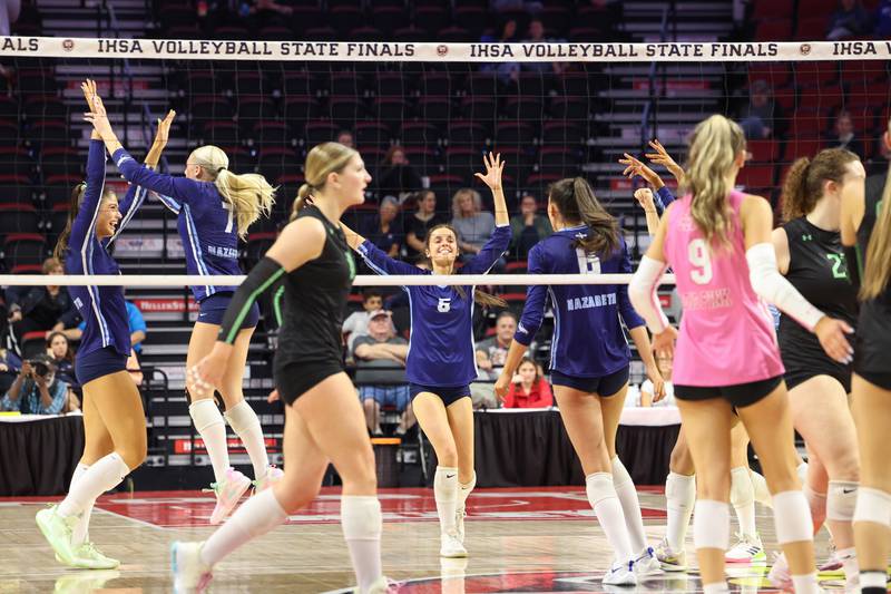 Nazareth's Beth Surowiec, center, celebrates a point with teammates during Nazareth's victory in two sets, 25-16, 25-17, over Providence in the IHSA Class 3A State semifinals on Friday, Nov. 14, 2025.