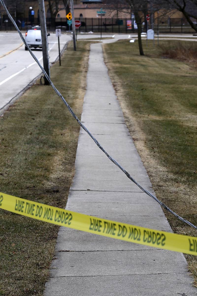 A power line hangs over a sidewalk on Dole Avenue near Eagle Street on Thursday, Feb. 23, 2023, as county residents recover from a winter storm that knocked down trees and created power outages throughout McHenry County.